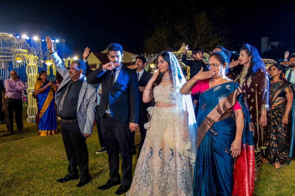 Bride and groom giving a flying kiss during their wedding celebration