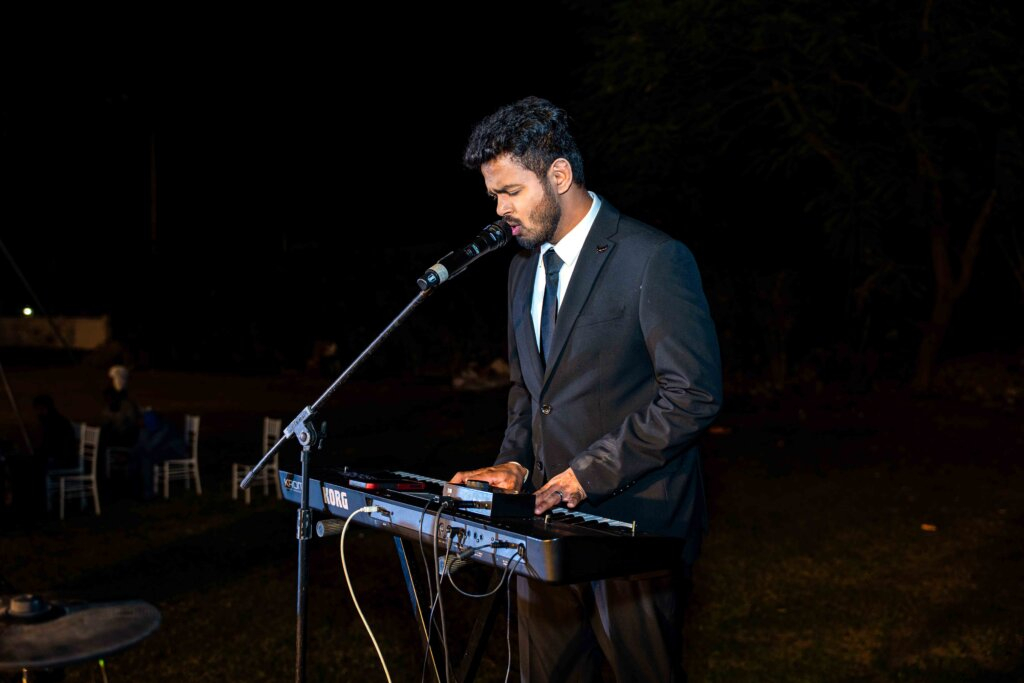 Groom playing the piano during the wedding celebration