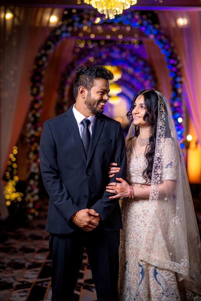Bride holding the groom’s hand while they gaze lovingly into each other’s eyes
