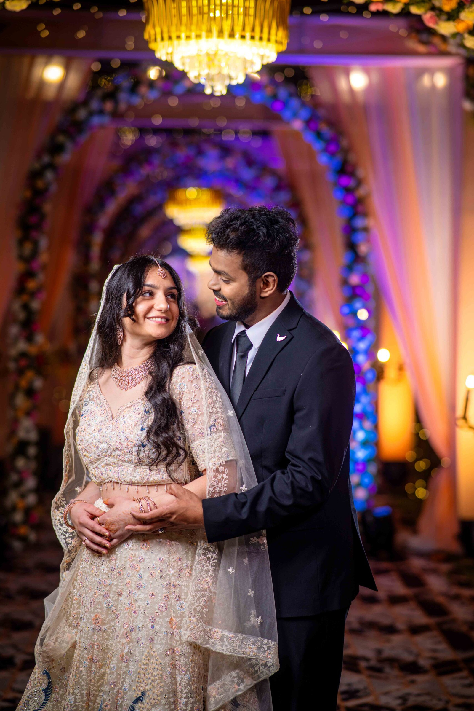 Christian wedding couple holding hands and posing elegantly for the camera