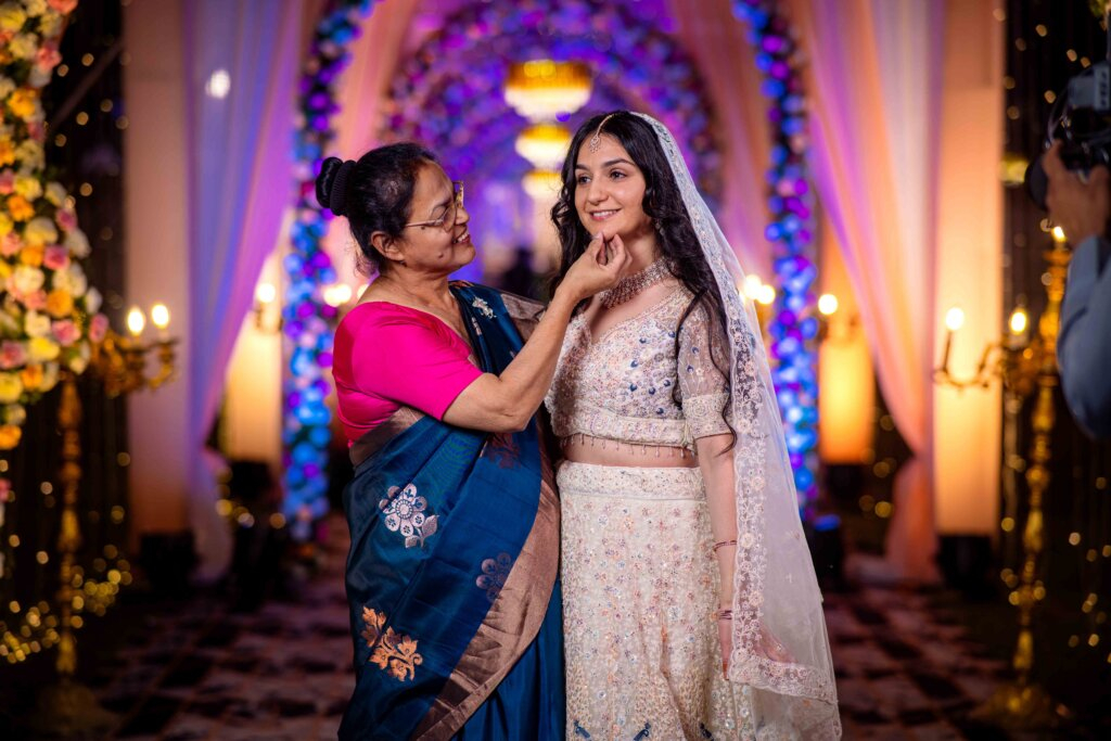Groom’s mother pampering the bride with love during the wedding celebration