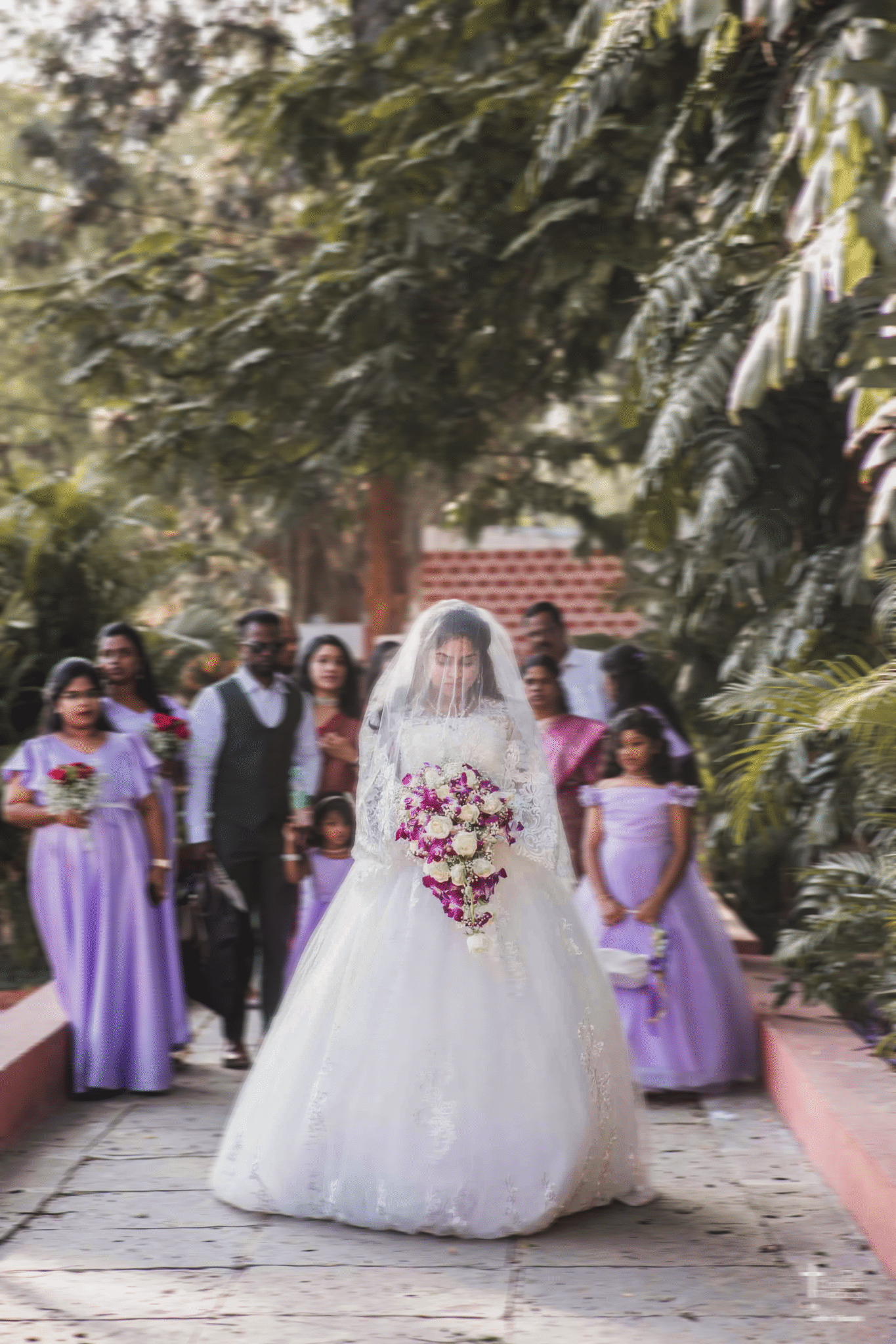 A bride gracefully walking towards a grand church, her veil flowing behind her and sunlight illuminating her path.