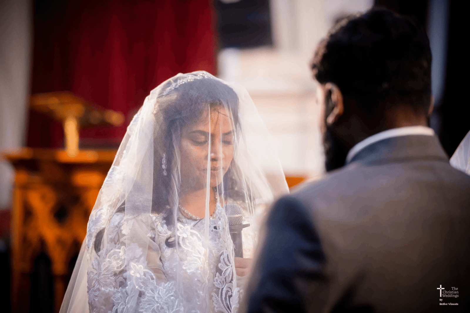 The bride and groom stand facing each other, their eyes locked in a loving gaze, radiating joy and anticipation.