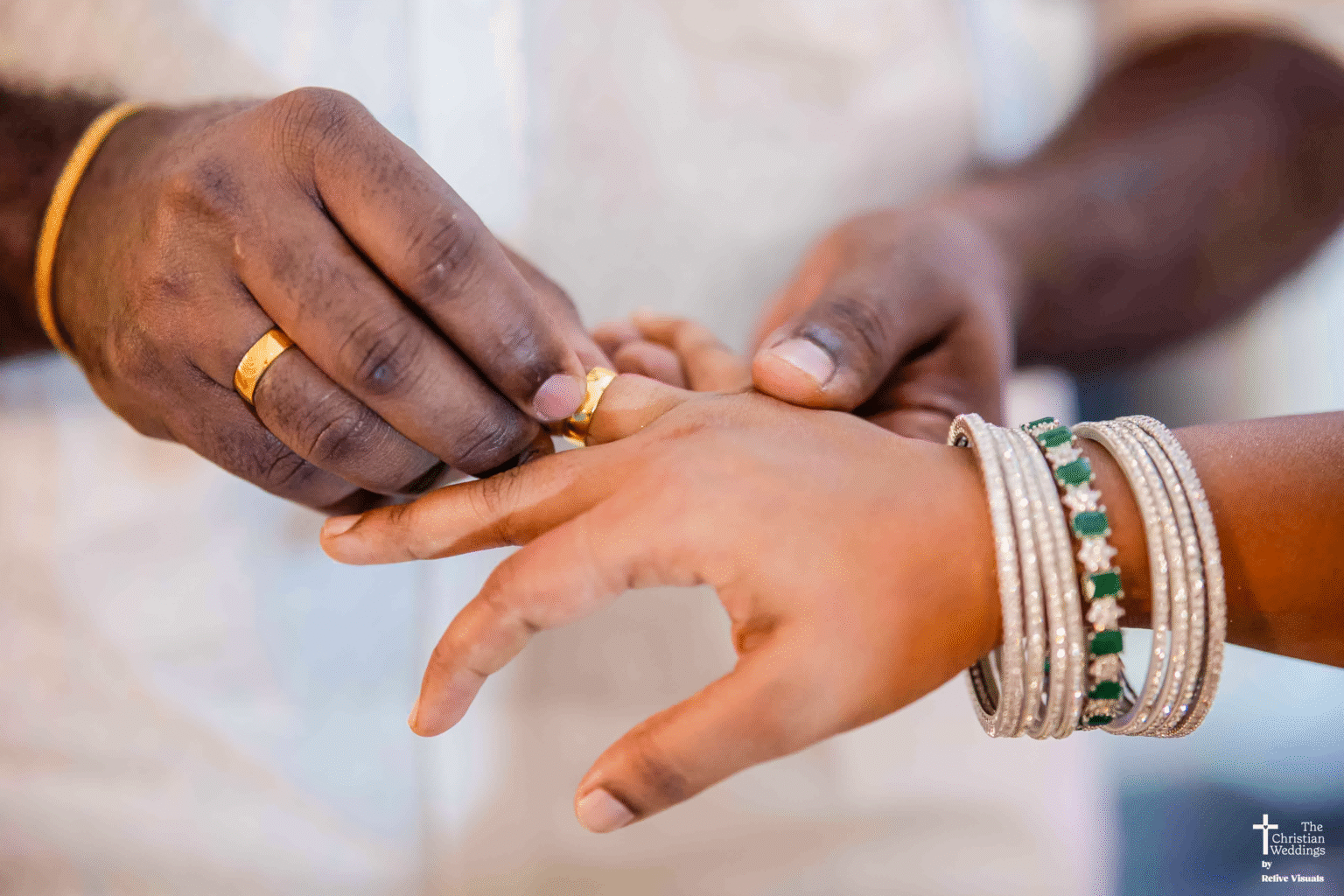 A close-up of the groom gently sliding a sparkling engagement ring onto the bride’s finger during their engagement ceremony.