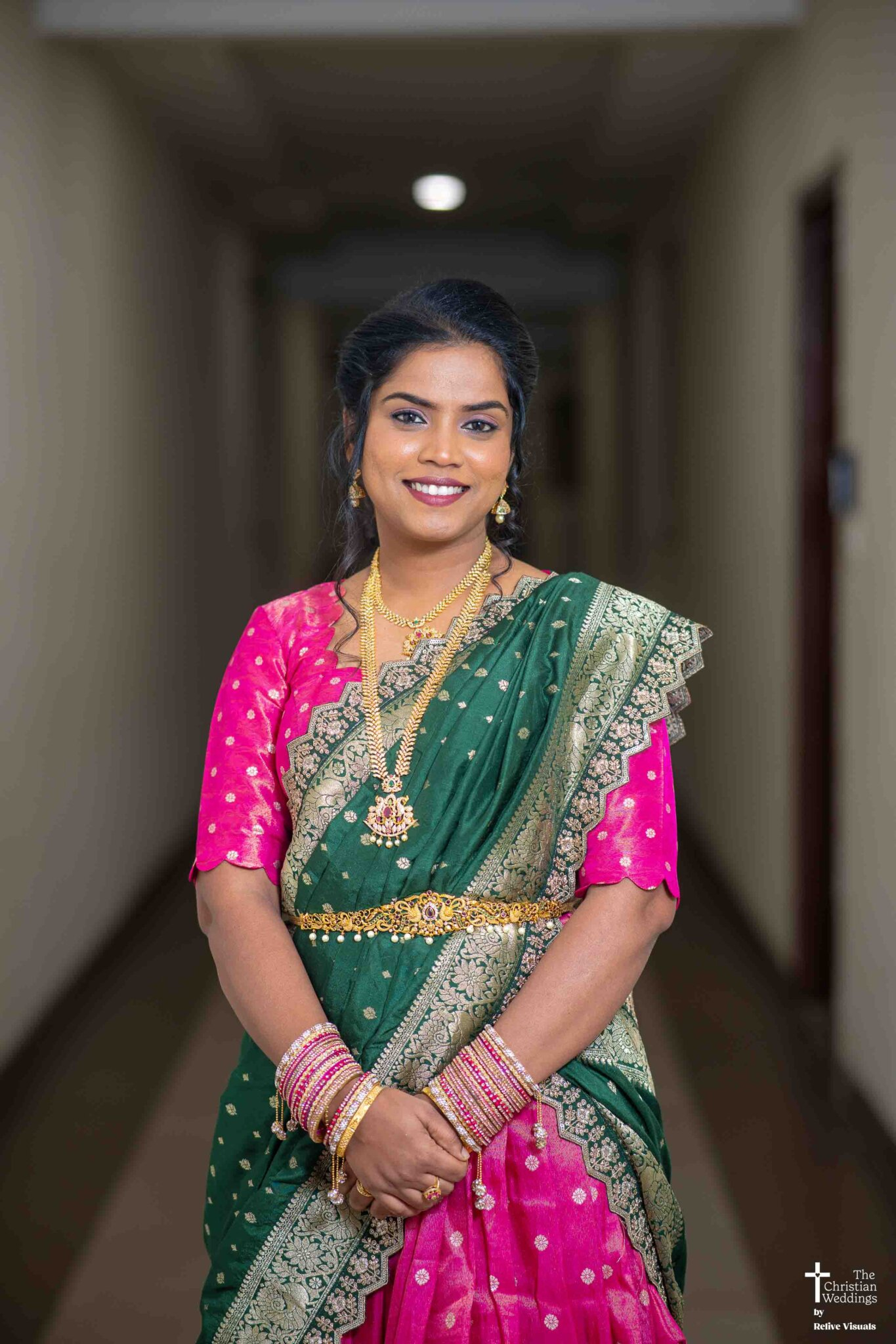 A Christian bride stands gracefully, her engagement ring sparkling as she holds her bouquet with a serene smile.
