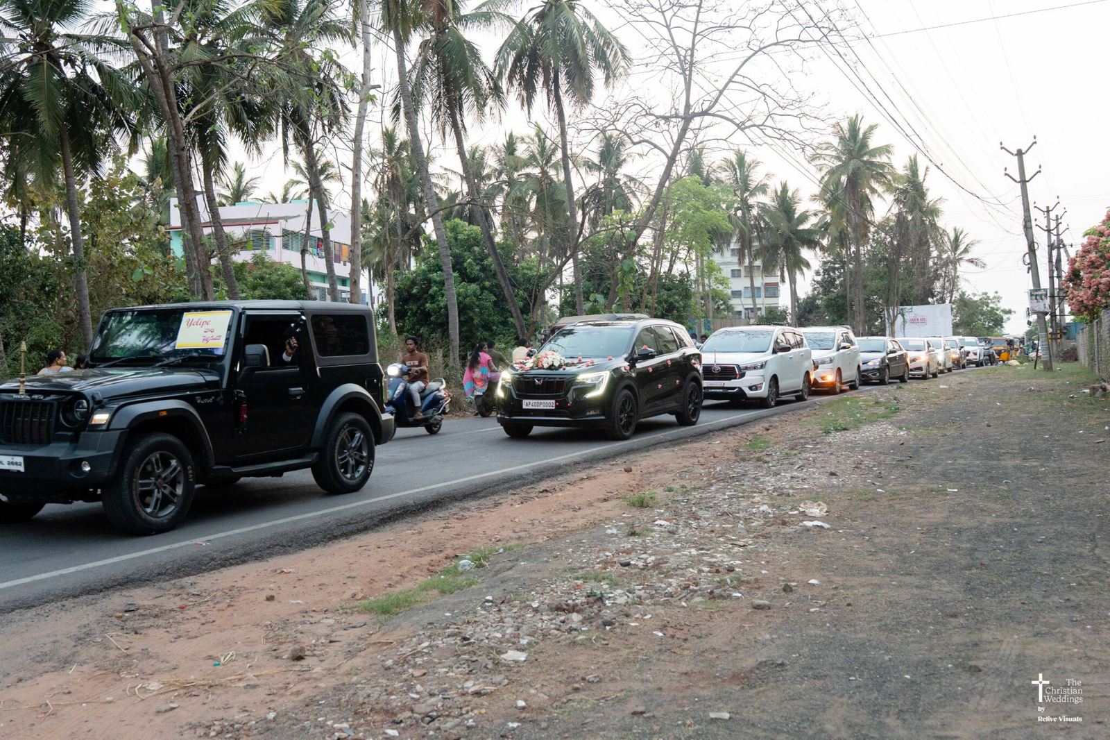 A fleet of decorated wedding cars lined up, ready to drive the bride and family to the Christian wedding venue.