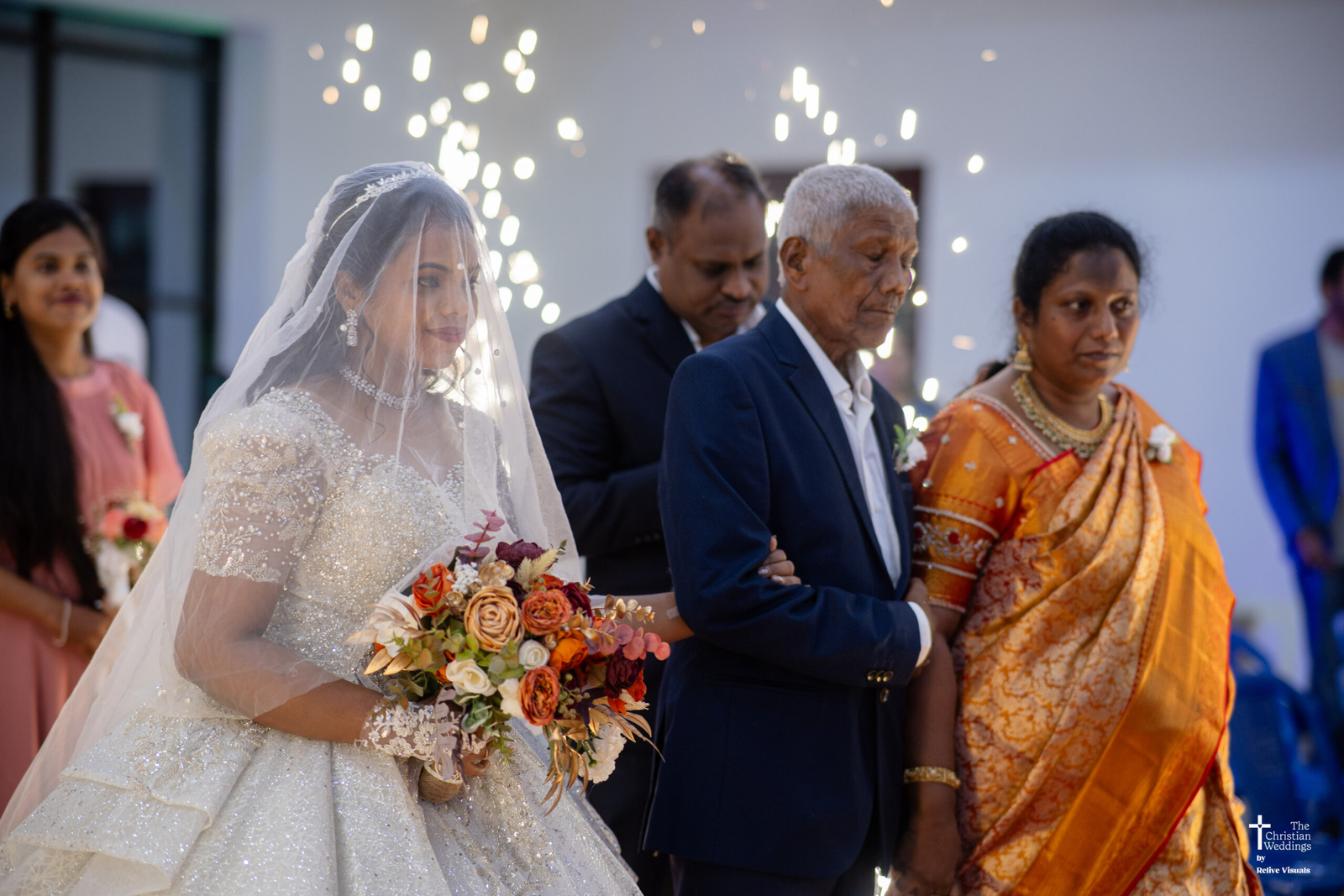 Christian bride walking down the aisle with her father, holding his arm, heading toward the altar inside the church.