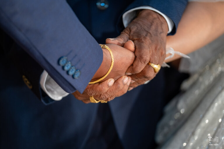 Bride and groom holding hands, sharing a quiet moment together